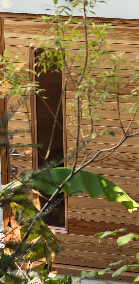 Larch-clad entrance to Blok Building's Gloucester Road project in Larkhall, Bath