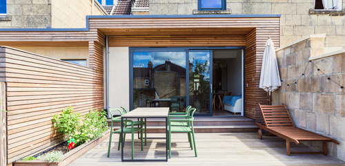 Junction Road side return extension in Bath - larch-clad rear elevation and terrace