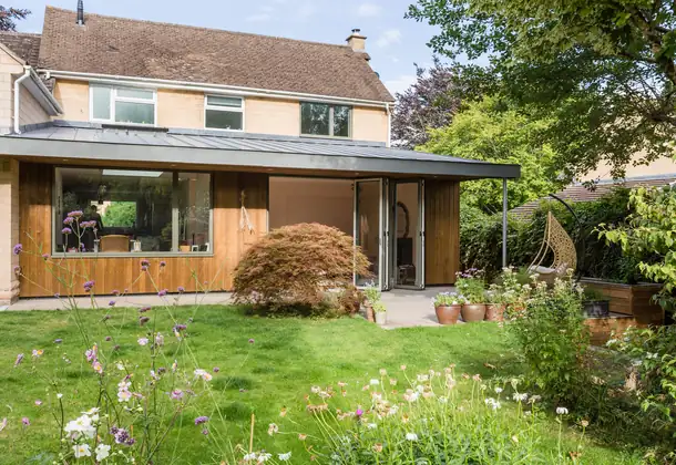 Barnfield Way rear kitchen extension in Bath featuring modern glazed doors and landscaped patio